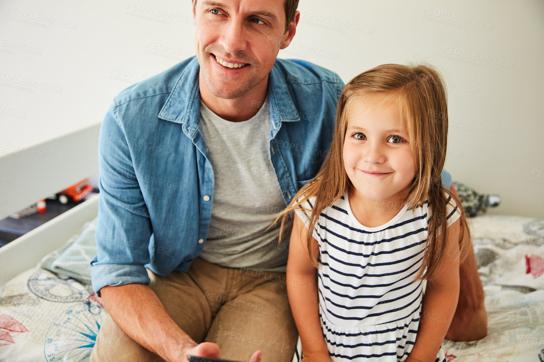 Buy stock photo Portrait of a smiling little girl sitting with her father at home