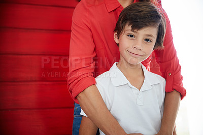 Buy stock photo Portrait of a smiling little boy standing with by his mother at home