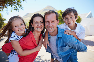Buy stock photo Portrait of a happy family with young children posing together outside their house