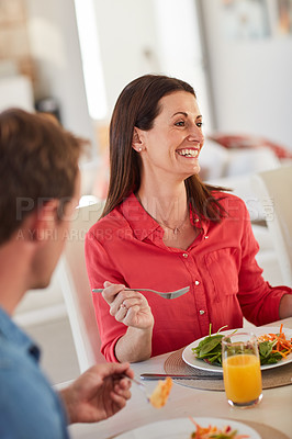 Buy stock photo Shot of a happy married couple enjoying a healthy meal together at home