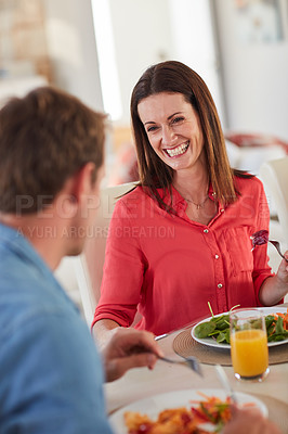 Buy stock photo Shot of a happy married couple enjoying a healthy meal together at home