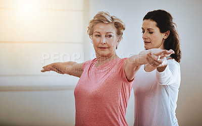 Buy stock photo Shot of a teacher helping a senior woman during a yoga class