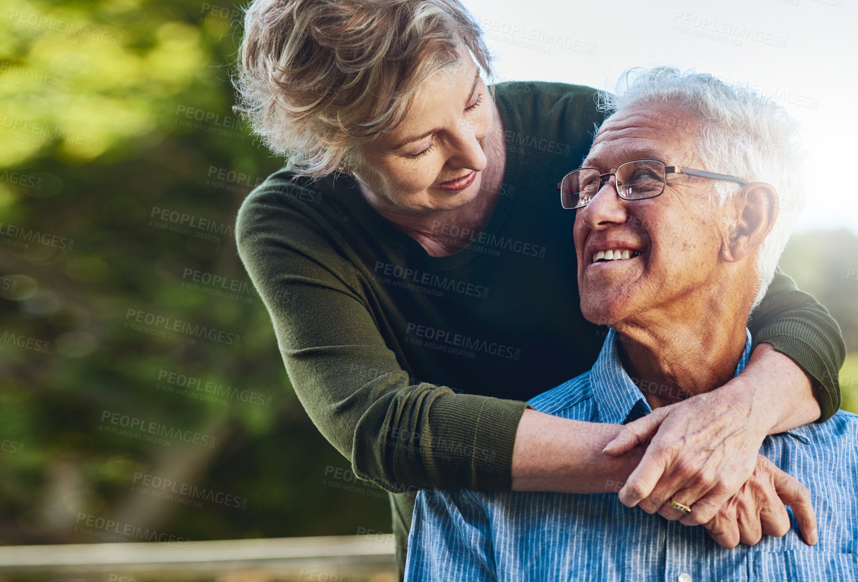 Buy stock photo Shot of a mature couple posing together in their backyard