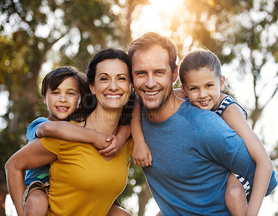 Buy stock photo Portrait of a family with two young children posing together outside