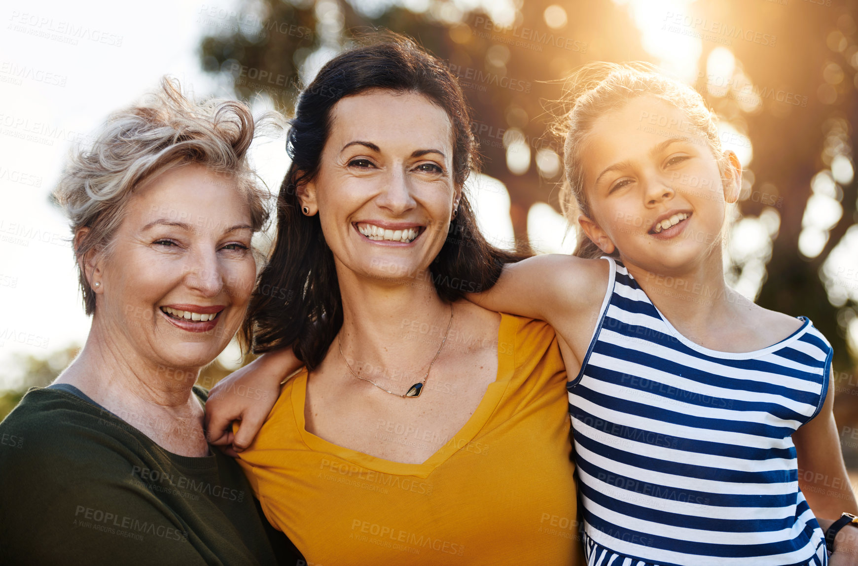 Buy stock photo Portrait of a cute little girl posing outside with her mother and grandmother