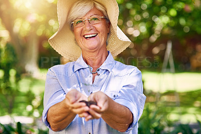 Buy stock photo Shot of a senior woman holding a handful of soil with a plant growing from it