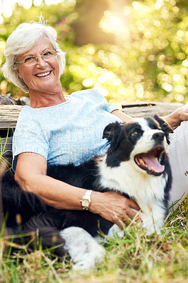 Buy stock photo Portrait of a happy senior woman relaxing in a park with her dog