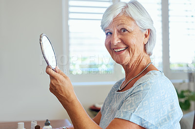 Buy stock photo Portrait of a happy senior woman using a hand mirror at home