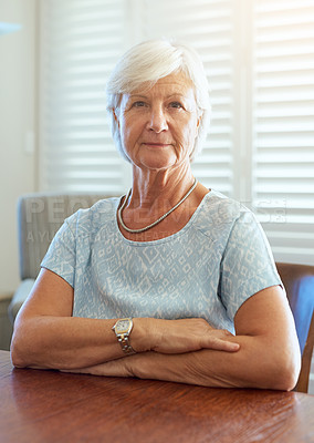 Buy stock photo Portrait of a happy senior woman sitting at a table at home