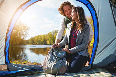 Buy stock photo Full length shot of an affectionate young couple at their campsite