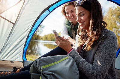 Buy stock photo Cropped shot of an affectionate young couple at their campsite