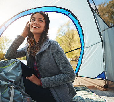 Buy stock photo Cropped shot of an attractive young woman sitting at her campsite