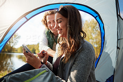 Buy stock photo Cropped shot of an affectionate young couple at their campsite