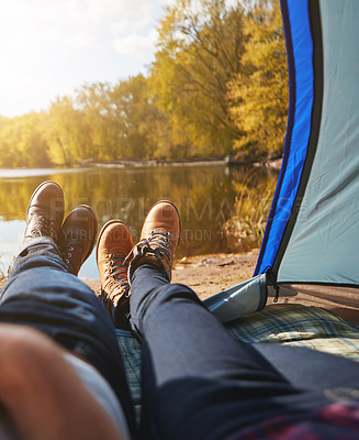 Buy stock photo Cropped shot of an unrecognizable couple lying in their tent