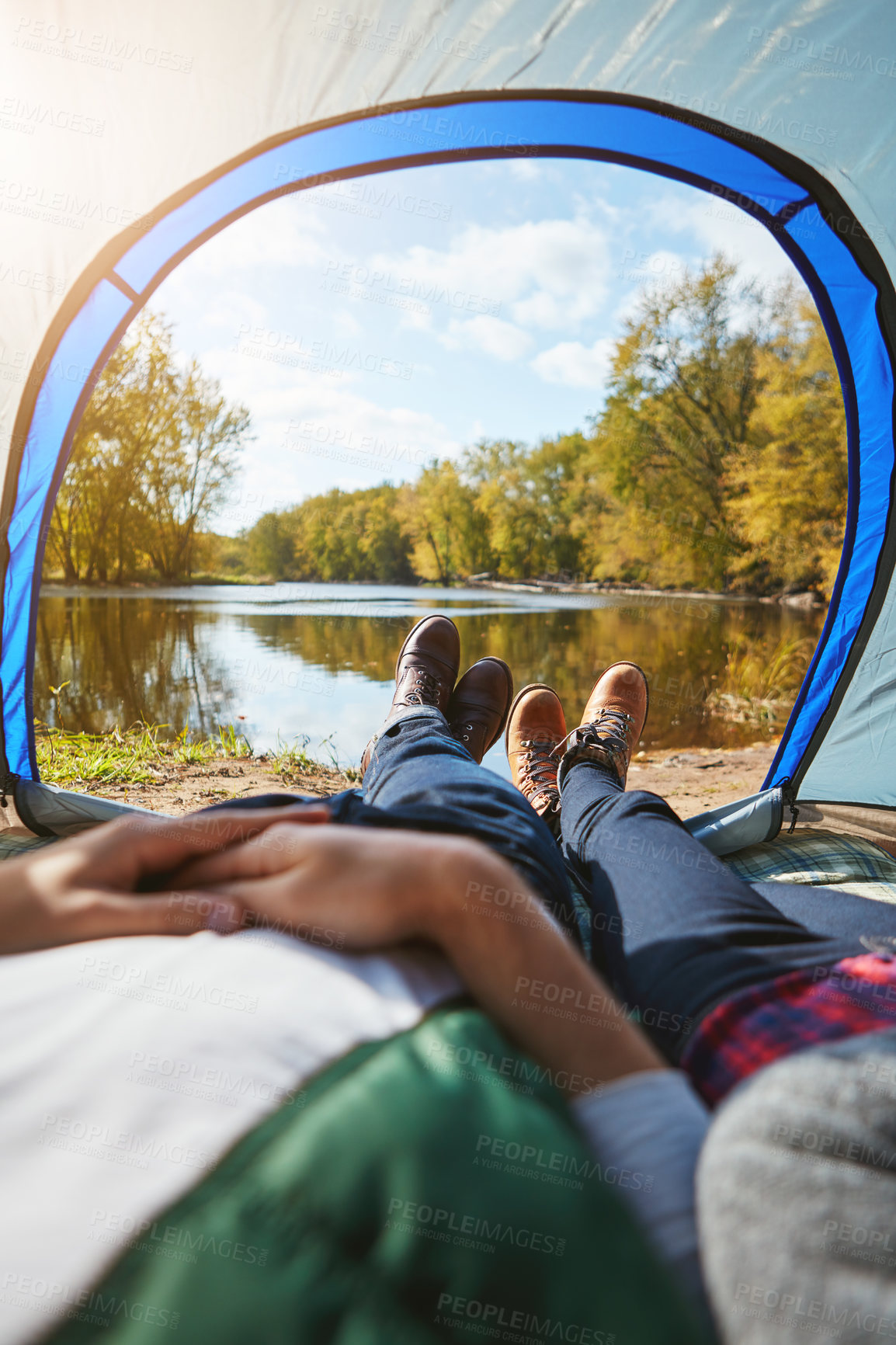 Buy stock photo Cropped shot of an unrecognizable couple lying in their tent