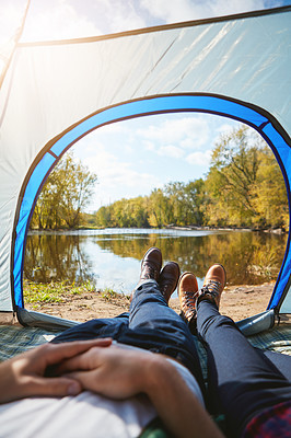 Buy stock photo Cropped shot of an unrecognizable couple lying in their tent