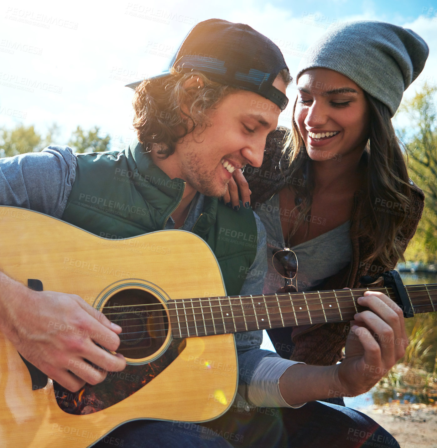 Buy stock photo Couple, outdoor and guitar for love song, care and bonding together with partner on vacation. Play string instrument, man and woman in nature for romantic music, smile and holiday for connection