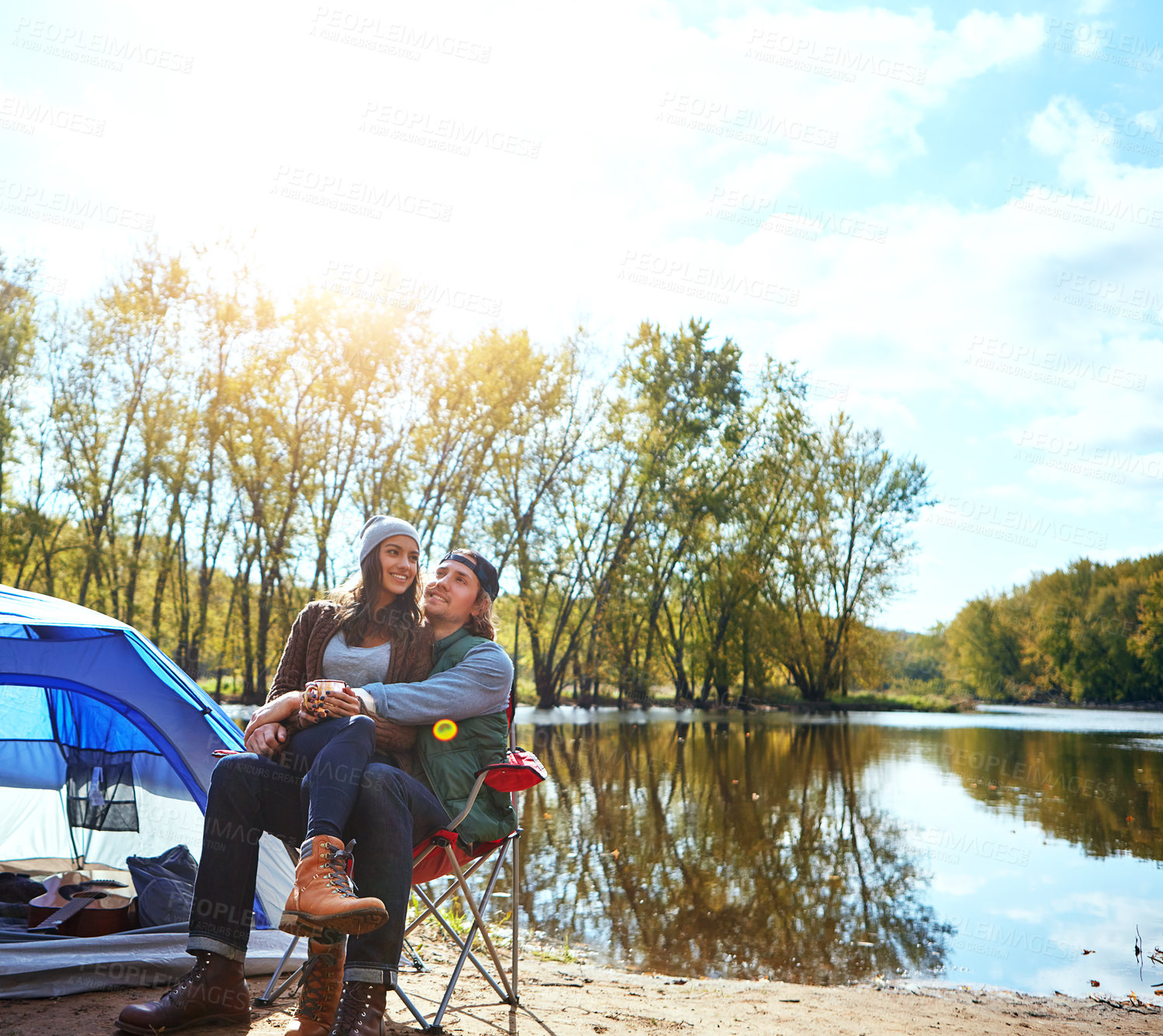 Buy stock photo Shot of a loving couple on a camping trip