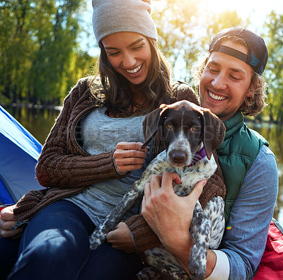 Buy stock photo Shot of a loving couple out camping with their dog