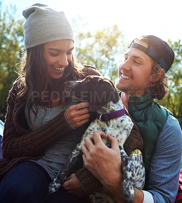 Buy stock photo Shot of a couple and their dog spending the day outdoors