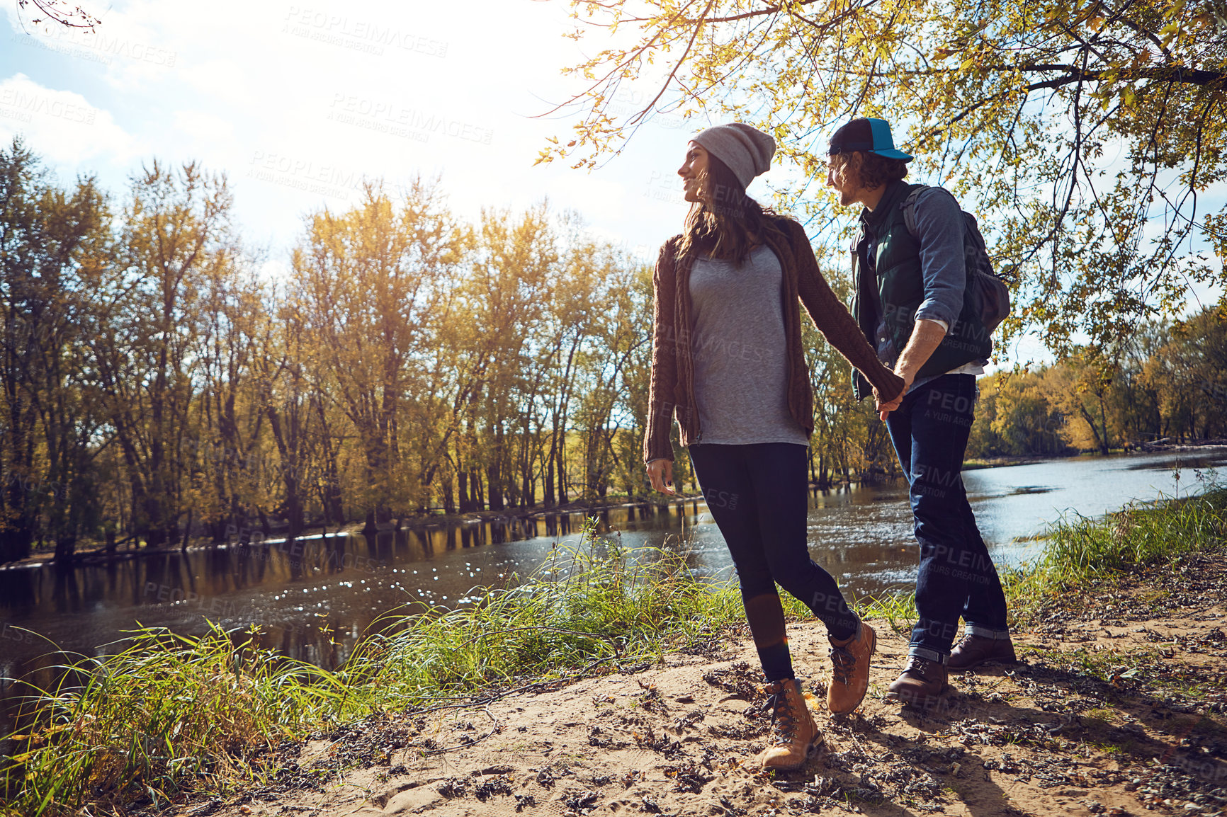 Buy stock photo Full length shot of an affectionate young couple spending a day in nature