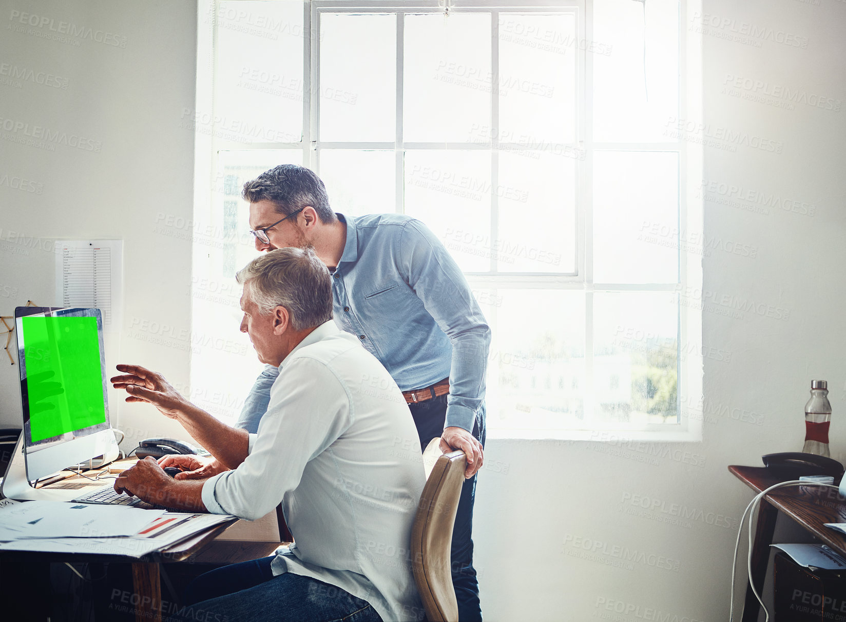 Buy stock photo Cropped shot of a mature businessman getting assistance from a colleague in the office