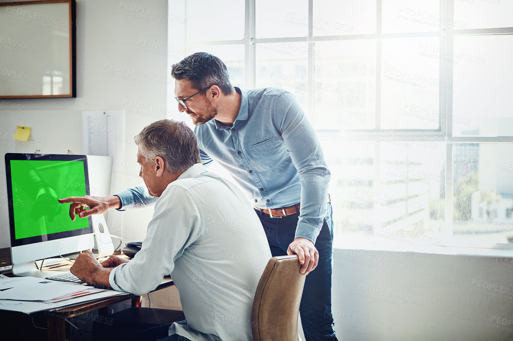 Buy stock photo Cropped shot of a mature businessman getting assistance from a colleague in the office