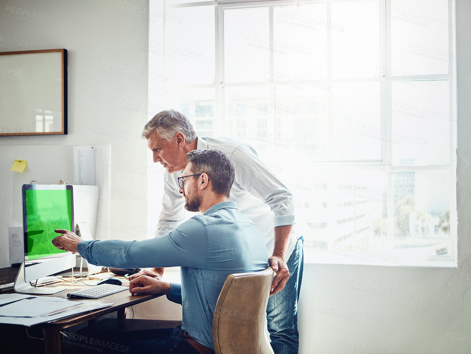 Buy stock photo Cropped shot of a mature businessman getting assistance from a colleague in the office