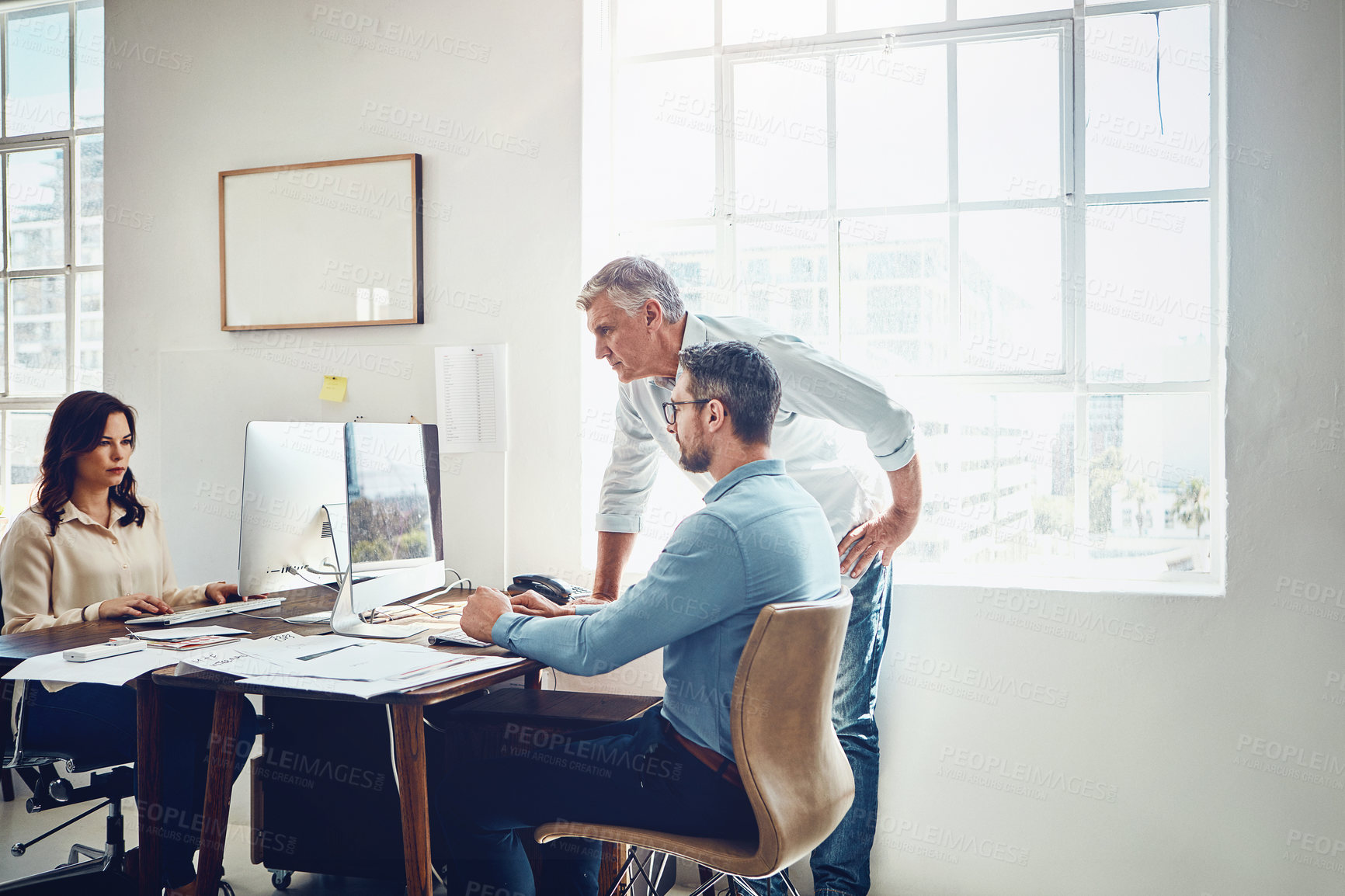 Buy stock photo Cropped shot of a mature businessman getting assistance from a colleague in the office