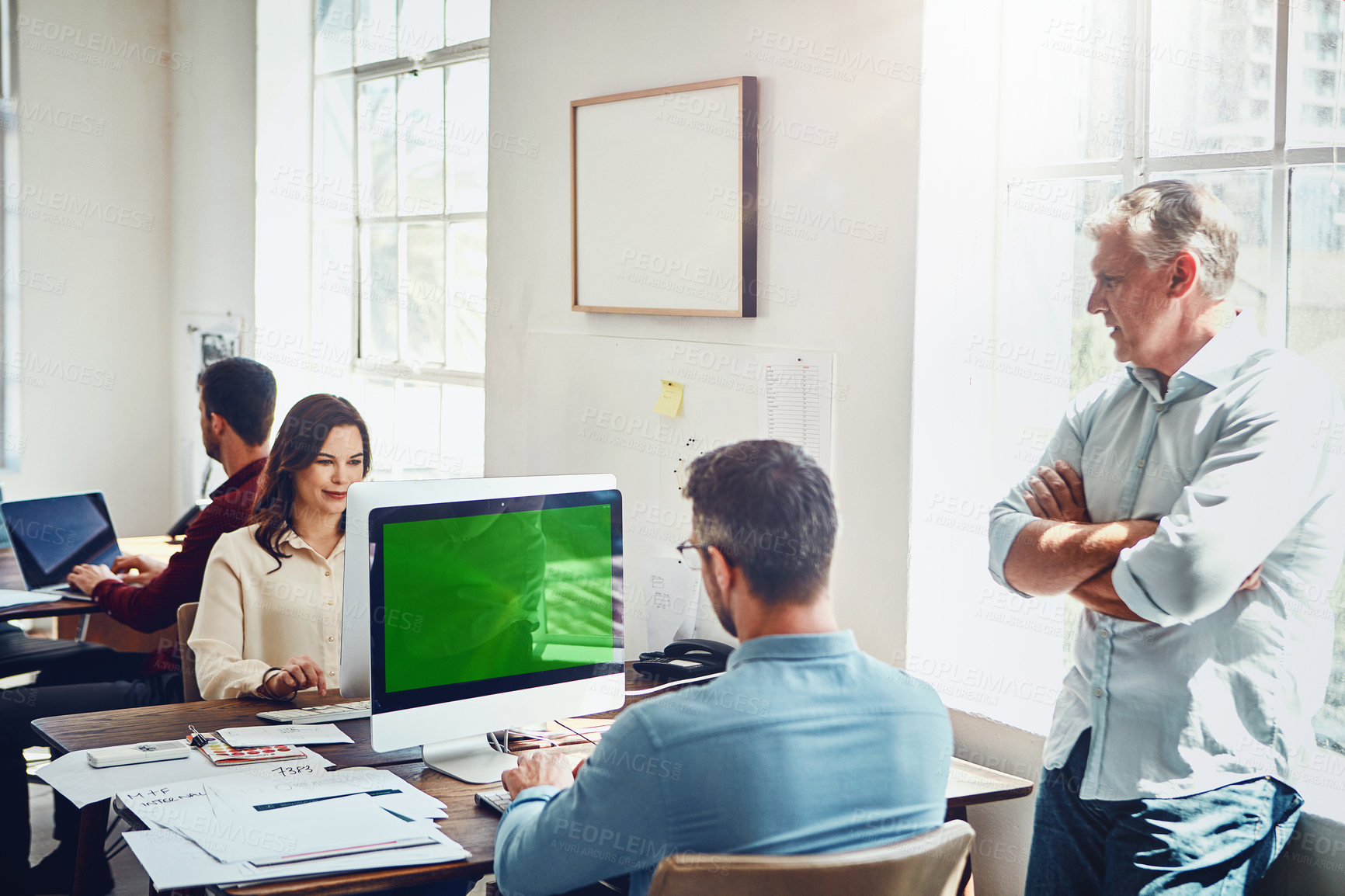 Buy stock photo Cropped shot of a group of colleagues working in their creative office