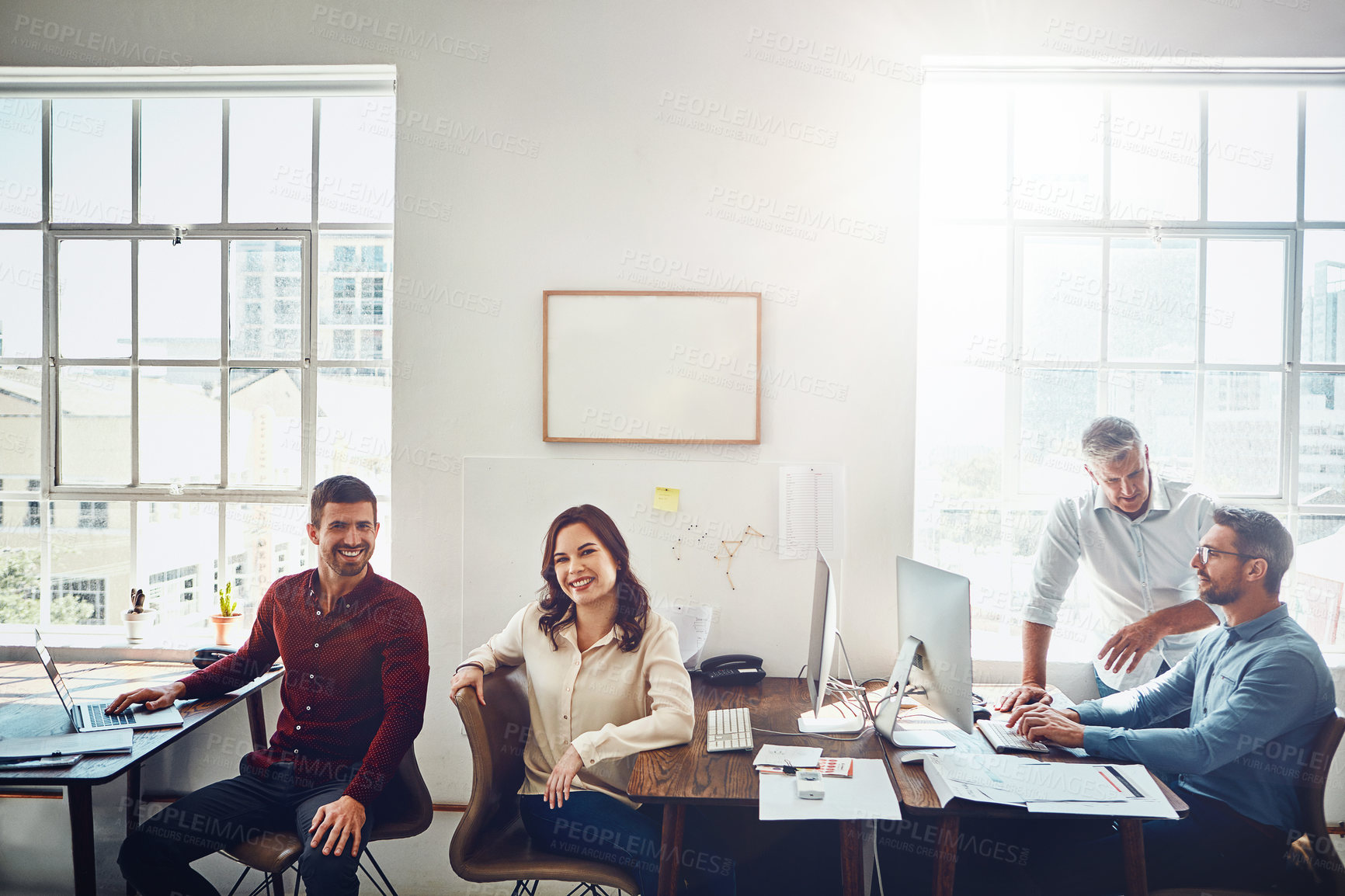 Buy stock photo Cropped shot of a group of colleagues working in their creative office