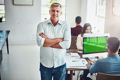 Buy stock photo Portrait of a mature man in the office with his colleagues working at their desks