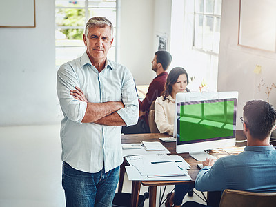 Buy stock photo Portrait of a mature man in the office with his colleagues working at their desks