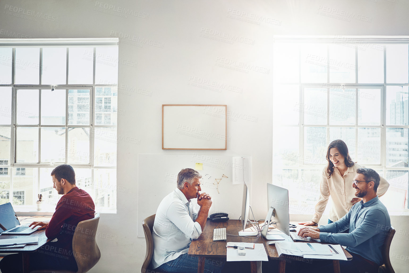 Buy stock photo Cropped shot of a group of colleagues working in their creative office