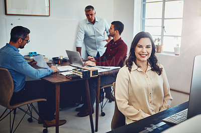 Buy stock photo Portrait of a young woman working in the office with her colleagues in the background