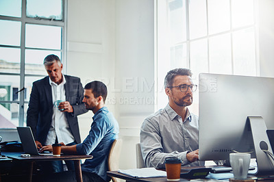 Buy stock photo Office building, working on computer and business people at table with manager, planning and email. Corporate workplace, teamwork and employees sitting at desk, in meeting and coworking on ideas
