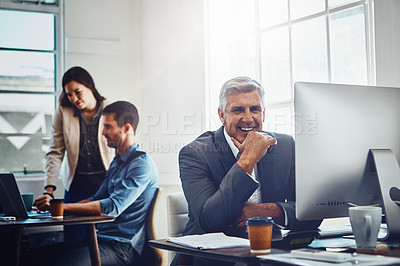 Buy stock photo Portrait, senior and business man by computer in office workplace. Pc, coworking and happy elderly male employee working on marketing report, advertising or sales project with colleagues in company.