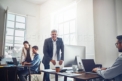 Buy stock photo Leadership, teamwork and portrait of business man in office workplace. Coworking, ceo and senior male employee working on marketing report, advertising or sales project with colleagues in company.
