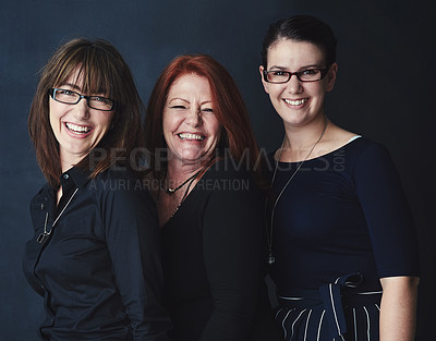 Buy stock photo Shot portrait of three businesswomen standing together against a dark background