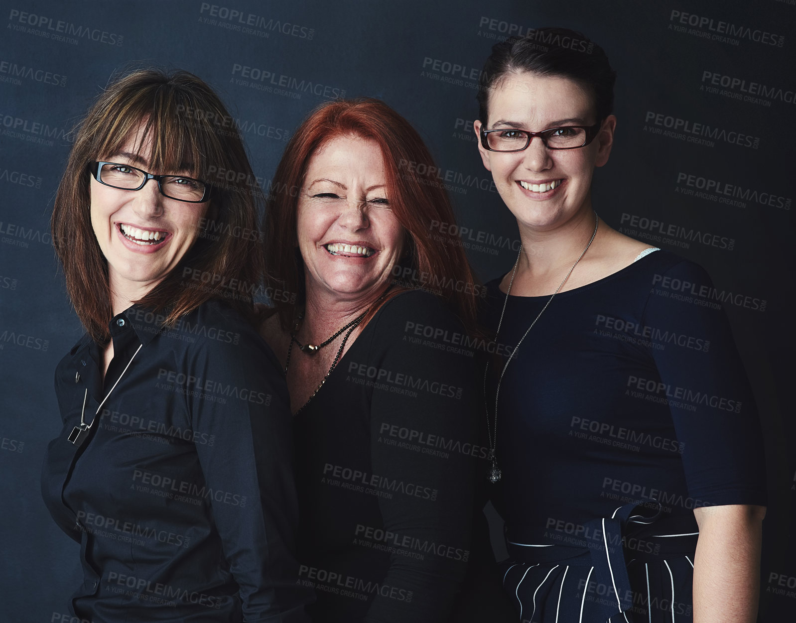 Buy stock photo Shot portrait of three businesswomen standing together against a dark background