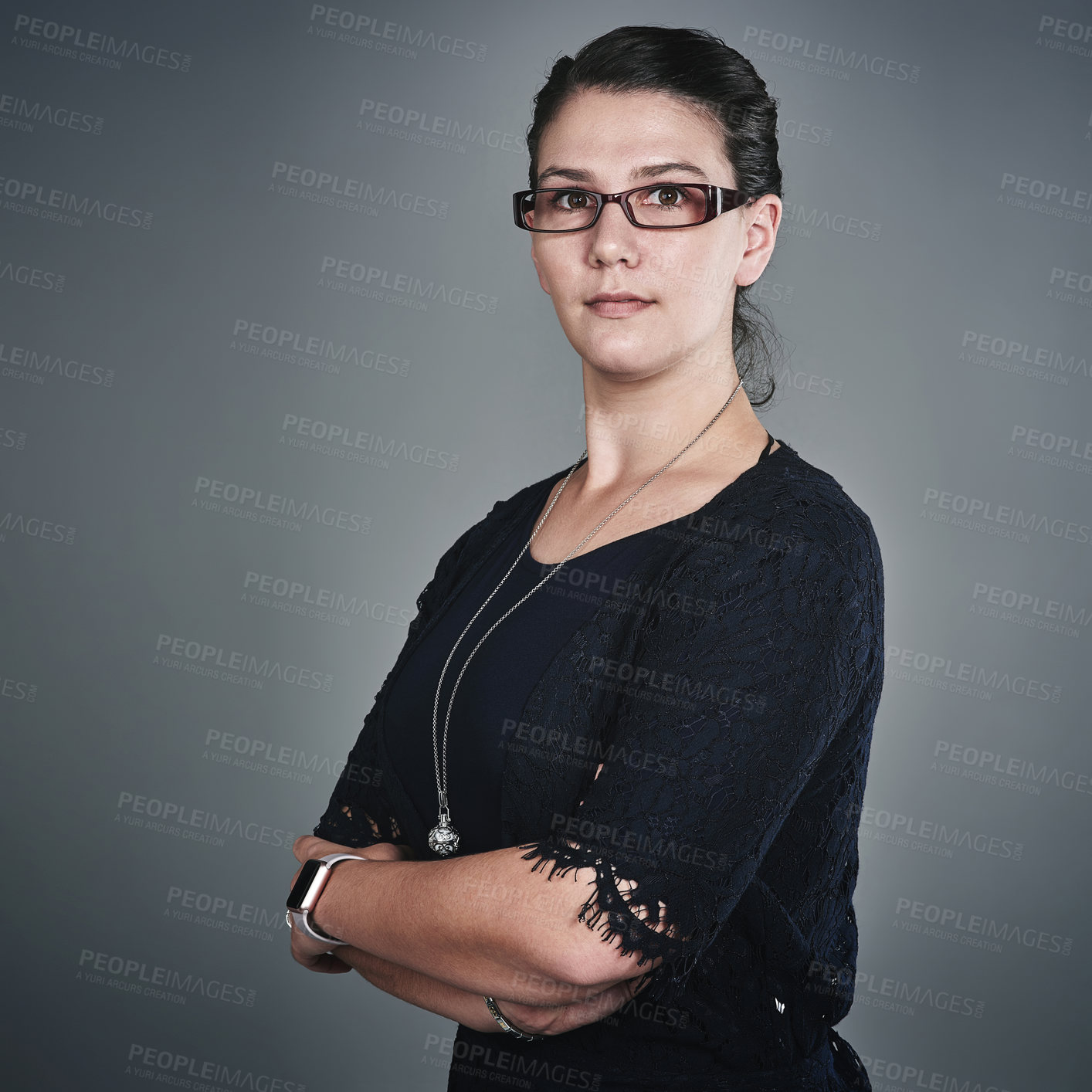 Buy stock photo Studio portrait of a confident young businesswoman posing against a grey background