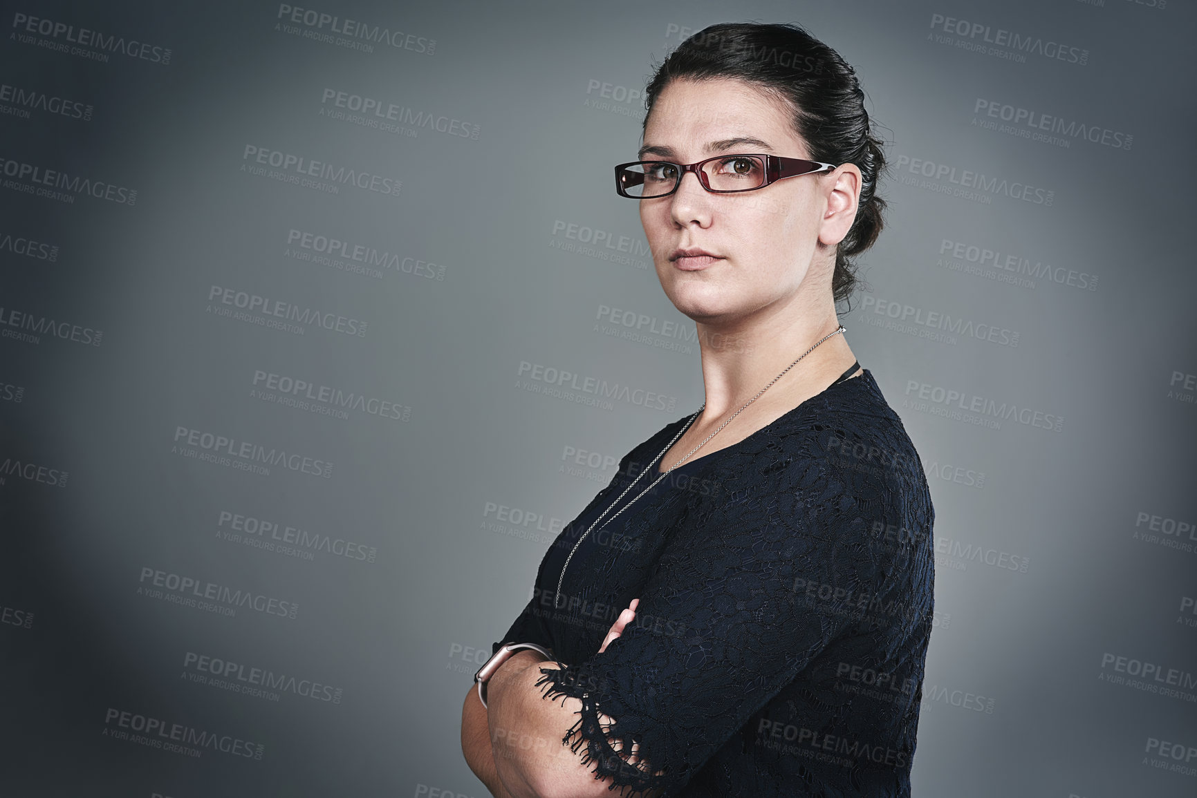 Buy stock photo Studio portrait of a confident young businesswoman posing against a grey background