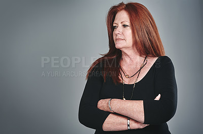 Buy stock photo Studio shot of a confident mature businesswoman posing against a grey background