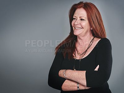Buy stock photo Studio shot of a confident mature businesswoman posing against a grey background