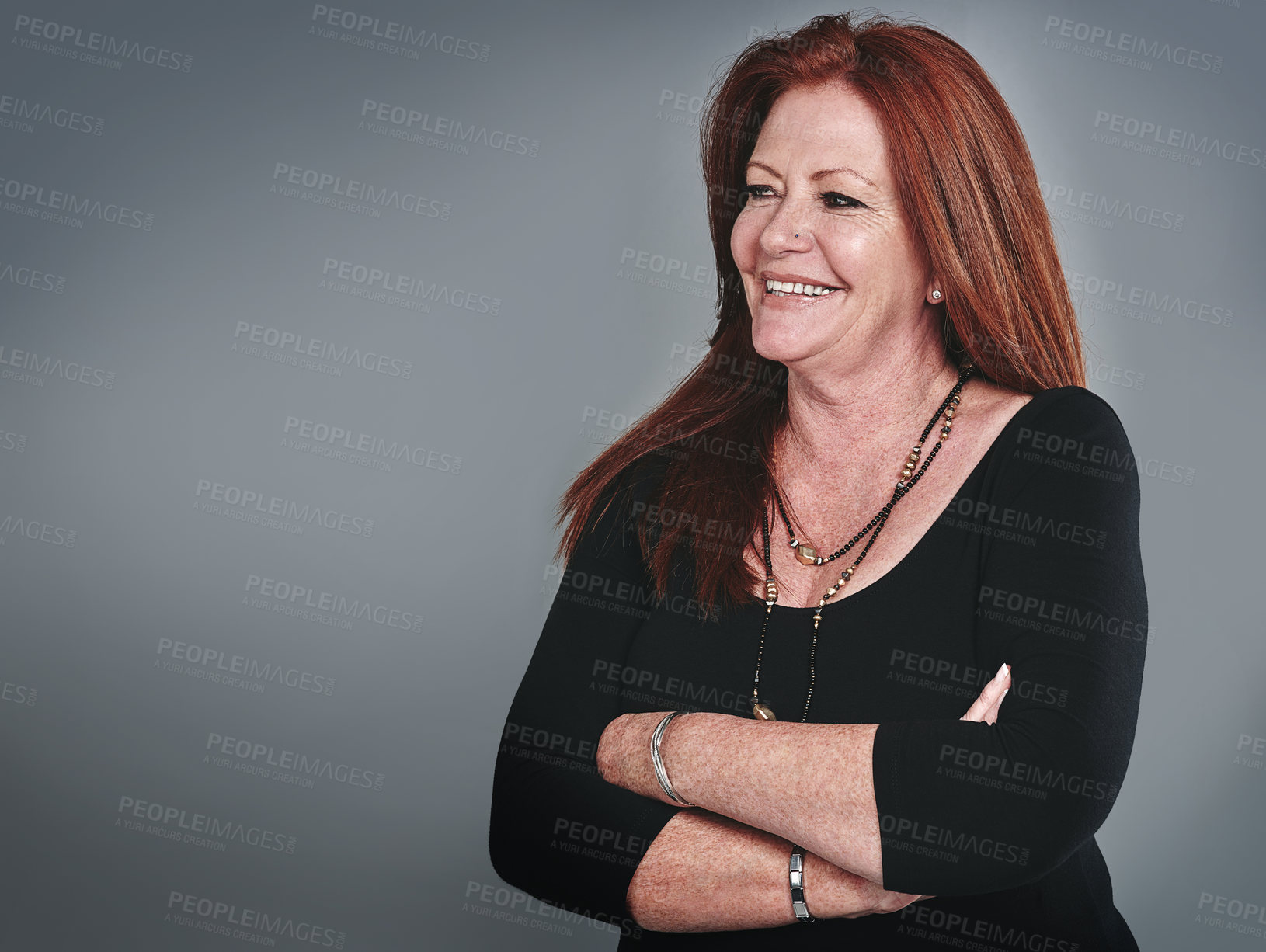 Buy stock photo Studio shot of a confident mature businesswoman posing against a grey background