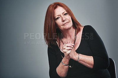 Buy stock photo Studio portrait of a businesswoman posing against a grey background