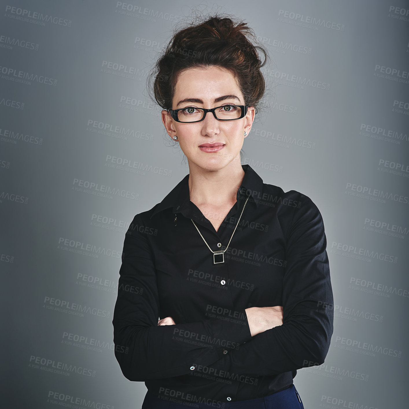 Buy stock photo Studio portrait of a confident young businesswoman posing against a grey background