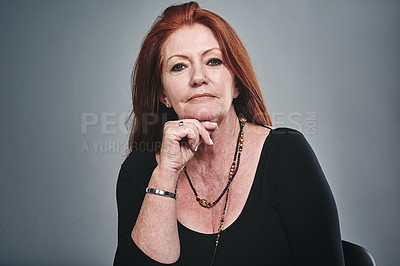 Buy stock photo Studio portrait of a confident mature businesswoman posing against a grey background