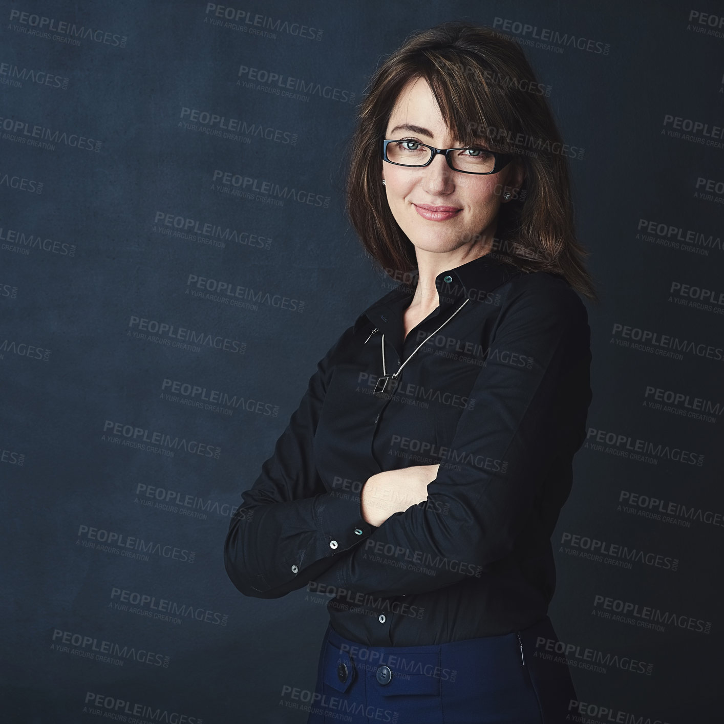 Buy stock photo Studio portrait of a corporate businesswoman posing against a dark background