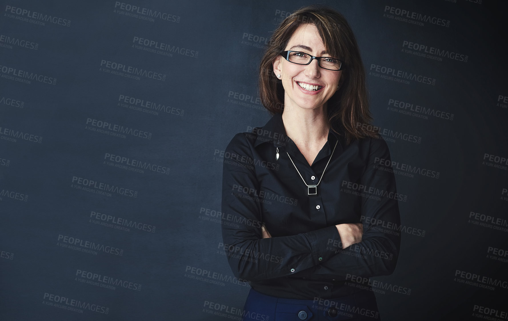 Buy stock photo Studio portrait of a corporate businesswoman posing against a dark background